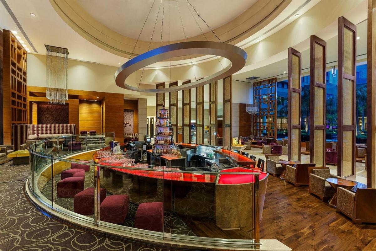 a lobby of a hotel with a bar in the middle at Crowne Plaza Today Gurugram by IHG in Gurgaon