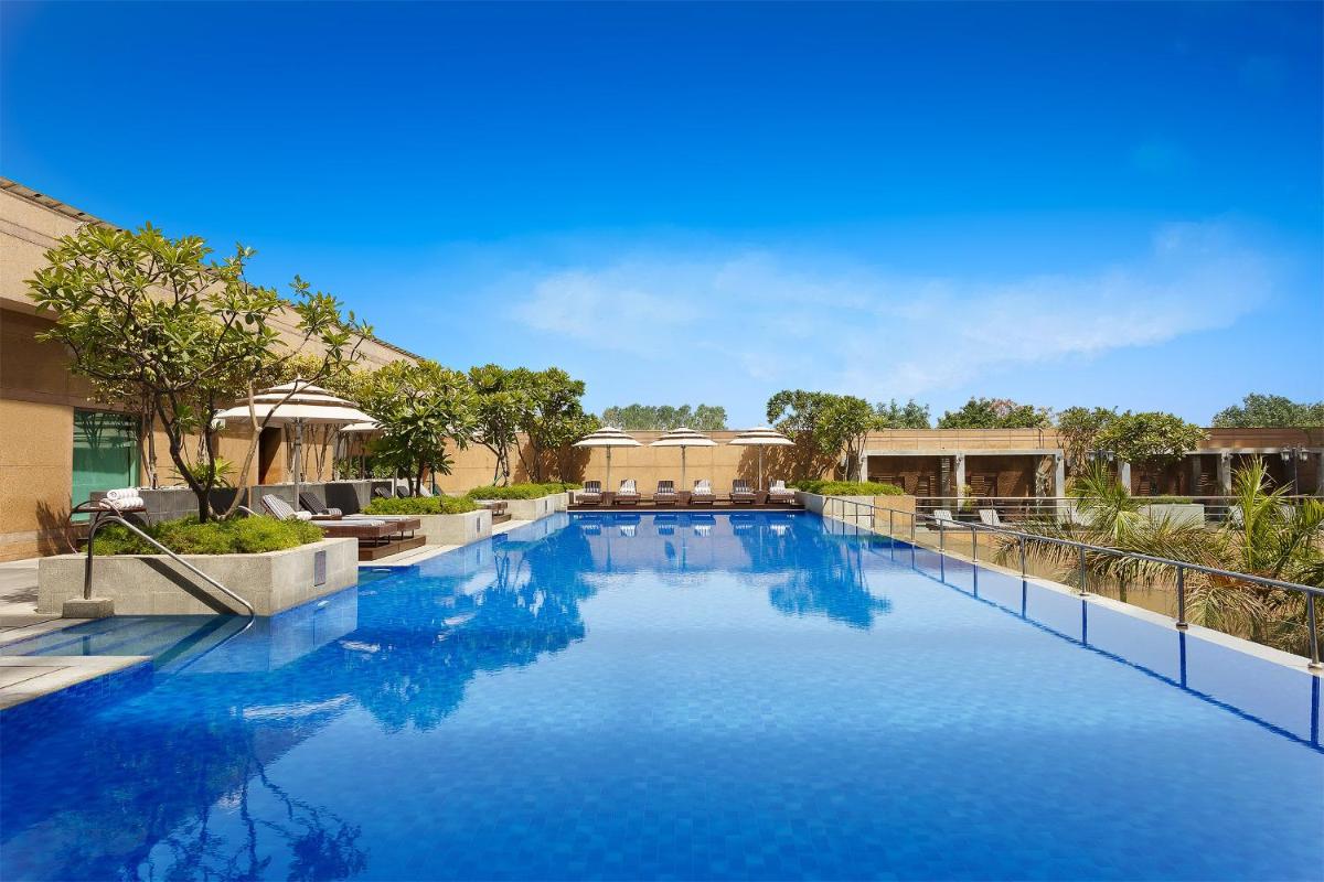 a large swimming pool with blue water at Crowne Plaza Today Gurugram by IHG in Gurgaon