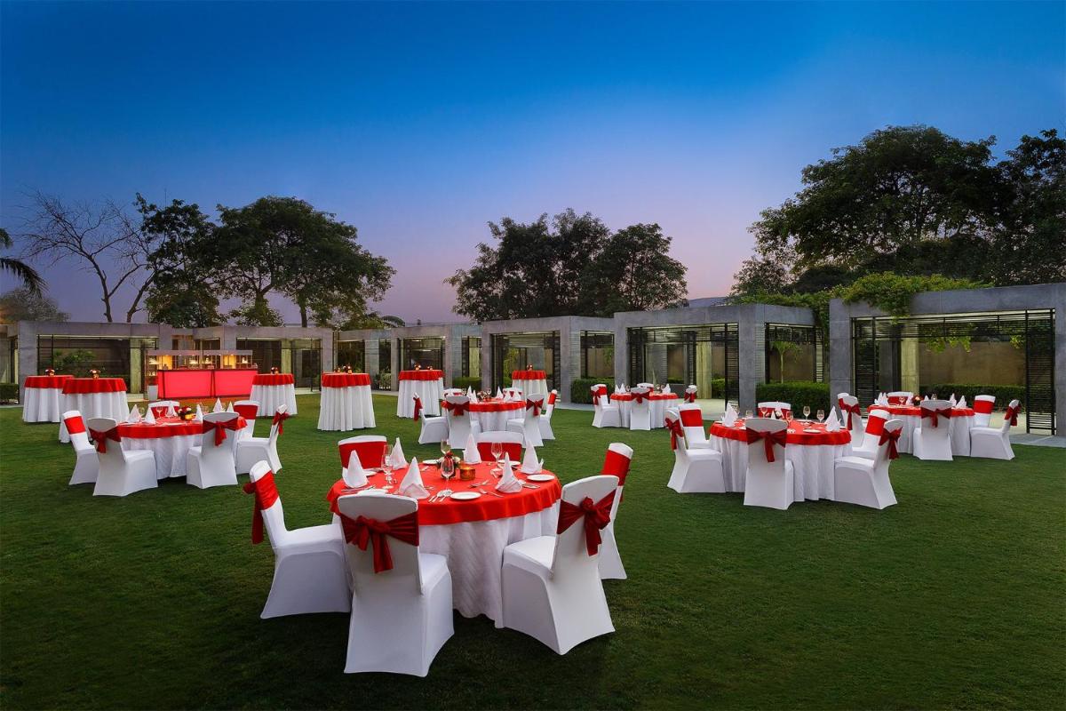 a group of tables and chairs in a field at Crowne Plaza Today Gurugram by IHG in Gurgaon +142 photos