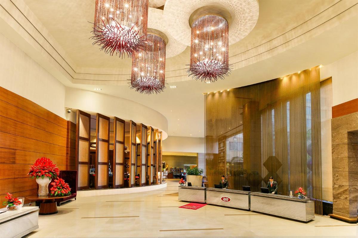 a lobby with two chandeliers in a building at Crowne Plaza Today Gurugram by IHG in Gurgaon