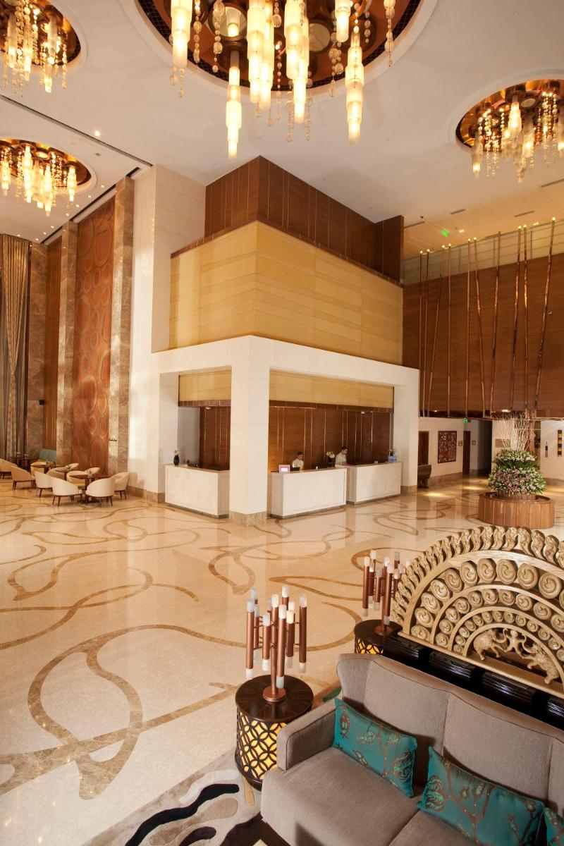 a lobby of a hotel with chairs and a table at Crowne Plaza New Delhi Okhla by IHG in New Delhi
