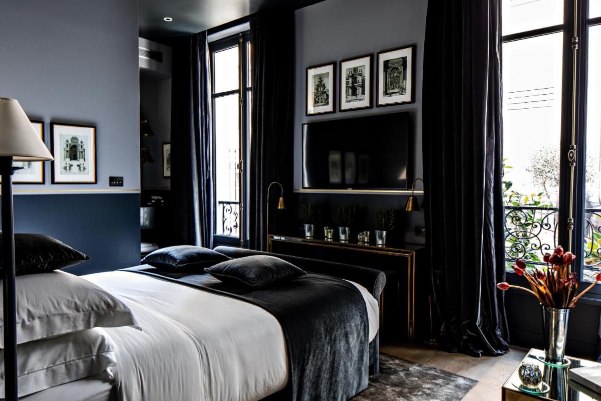 Un ou plusieurs lits dans un hébergement de l'établissement Monsieur George Hotel & Spa - Champs-Elysées