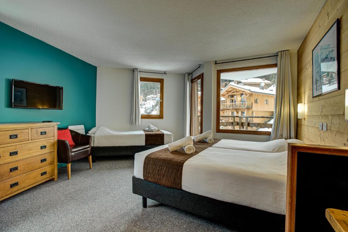 Un ou plusieurs lits dans un hébergement de l'établissement Hôtel Le Montana