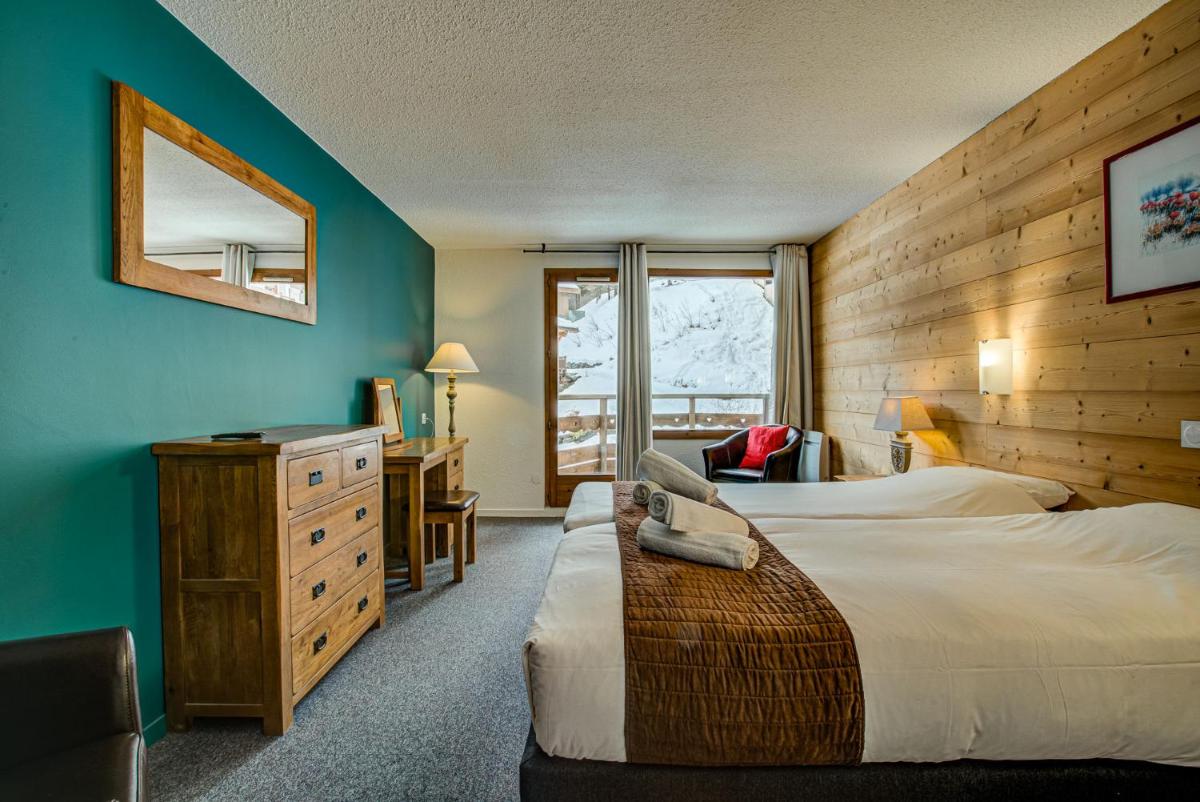 Un ou plusieurs lits dans un hébergement de l'établissement Hôtel Le Montana