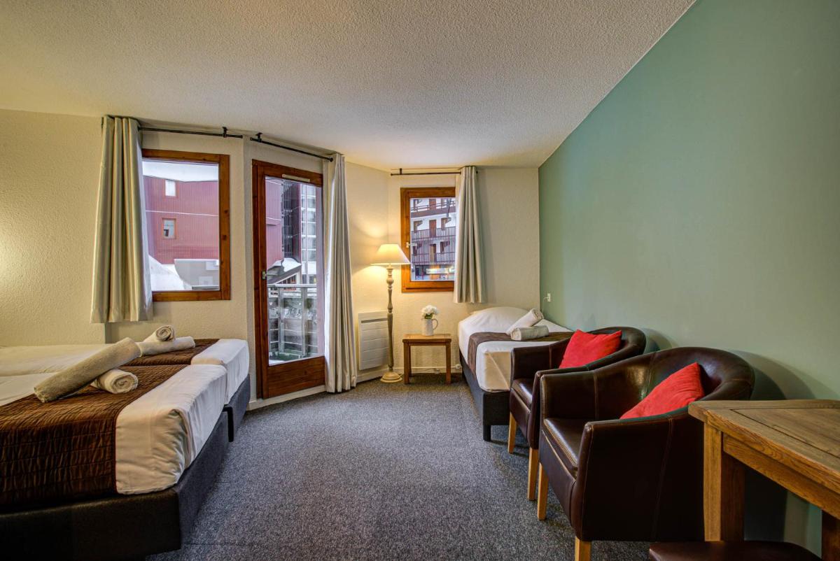 Un ou plusieurs lits dans un hébergement de l'établissement Hôtel Le Montana