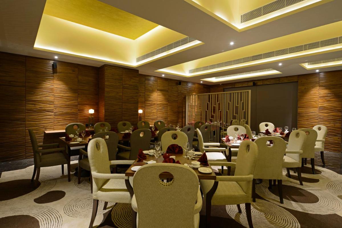 a dining room with tables and chairs in a room at Sun-n-Sand Mumbai Juhu Beach in Mumbai