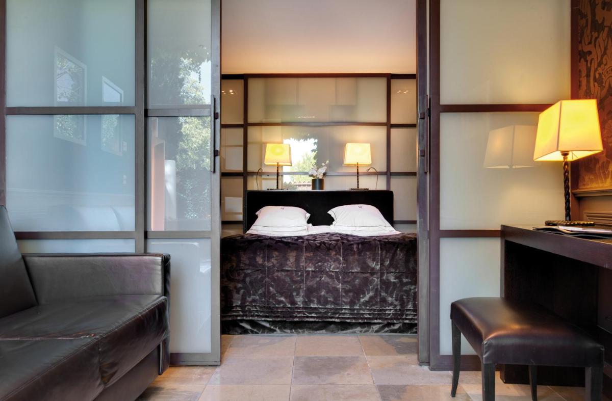Un ou plusieurs lits dans un hébergement de l'établissement Hôtel du Château & Spa - Teritoria