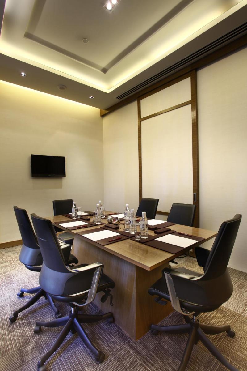 a conference room with a long table and chairs at Crowne Plaza New Delhi Rohini by IHG in New Delhi a conference room with a long table and chairs at Crowne Plaza New Delhi Rohini by IHG in New Delhi