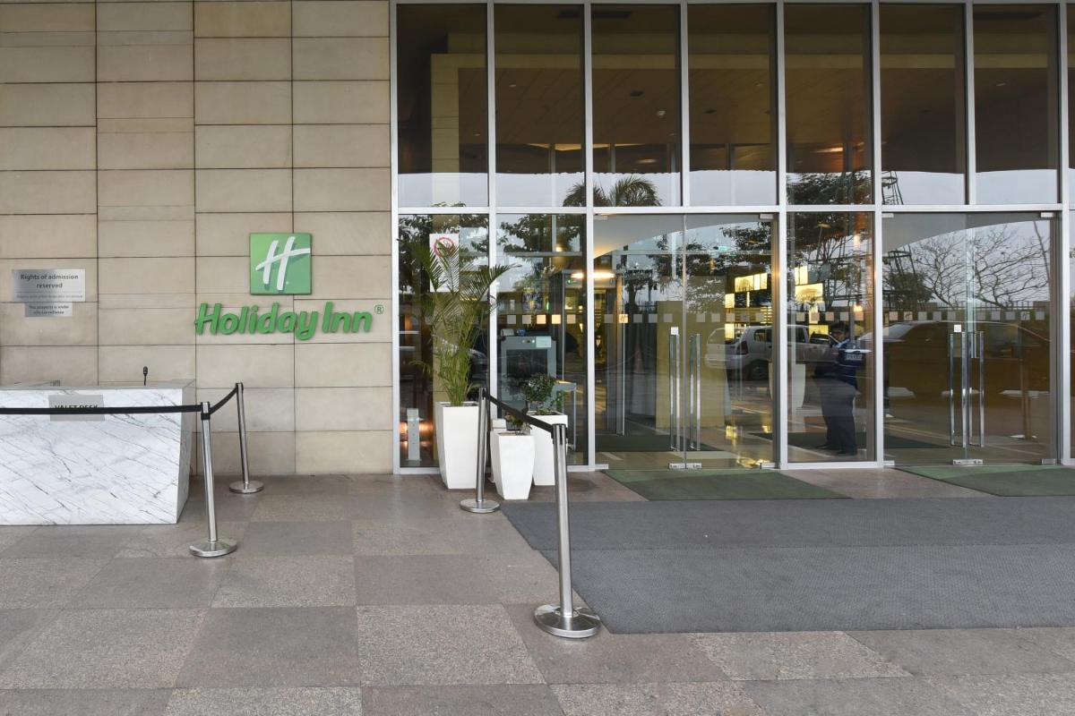 a building with a sign on the side of it at Holiday Inn New Delhi Aerocity by IHG in New Delhi