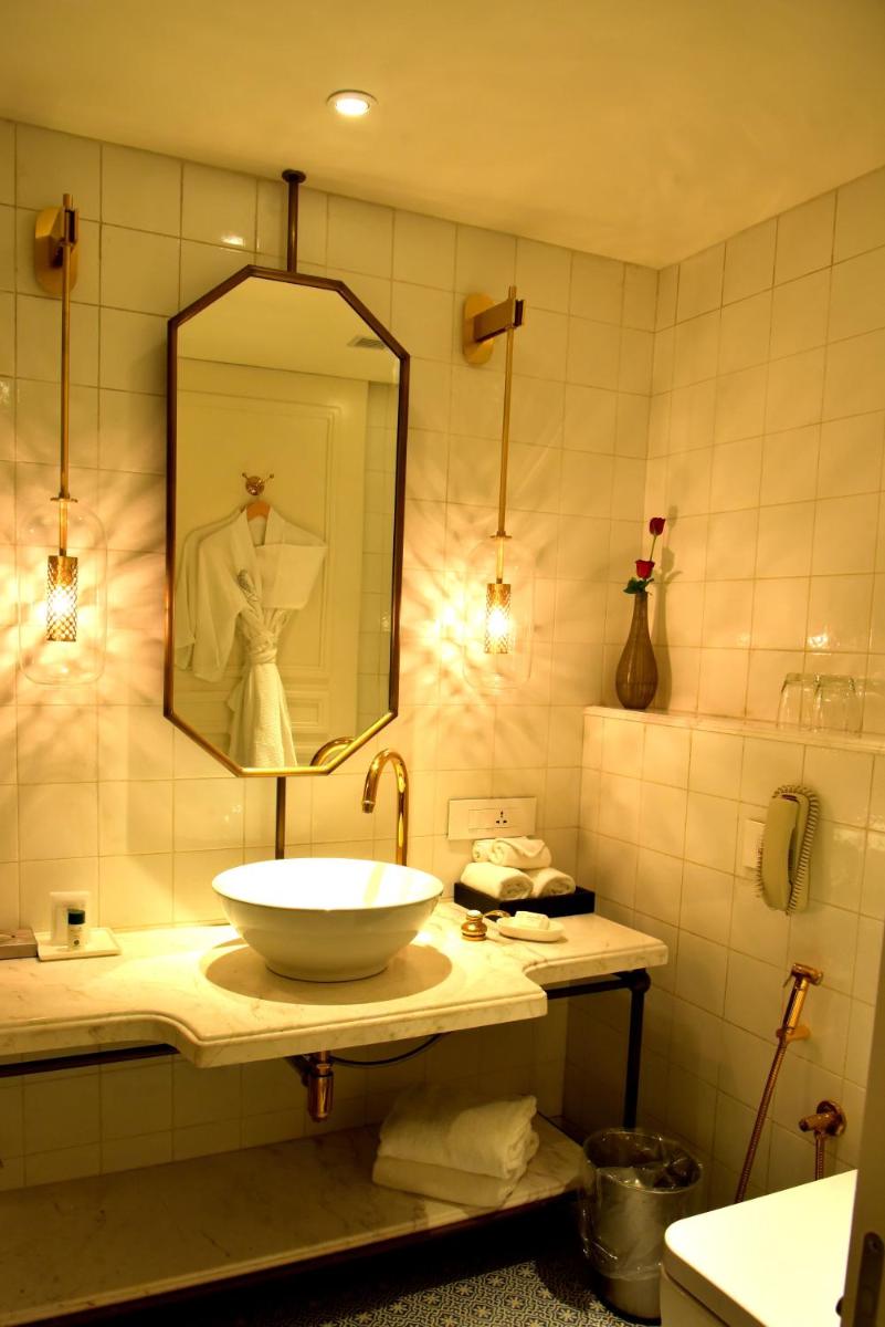 a bathroom with a sink and a mirror at Radisson Hotel Shimla in Shimla