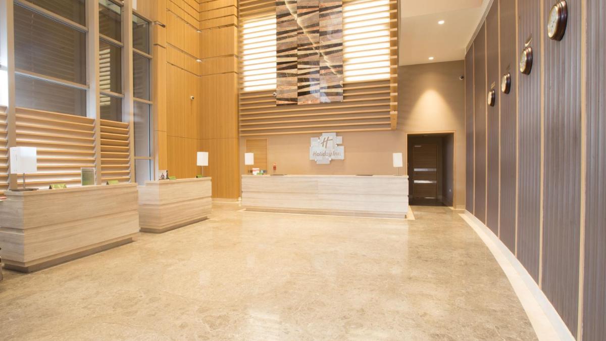 a large room with wooden walls and a large hallway at Holiday Inn Chennai OMR IT Expressway by IHG in Chennai