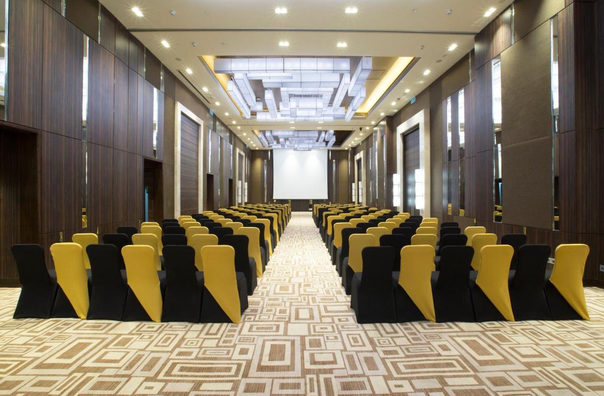 a row of chairs in a hall with a screen at Holiday Inn Chennai OMR IT Expressway by IHG in Chennai