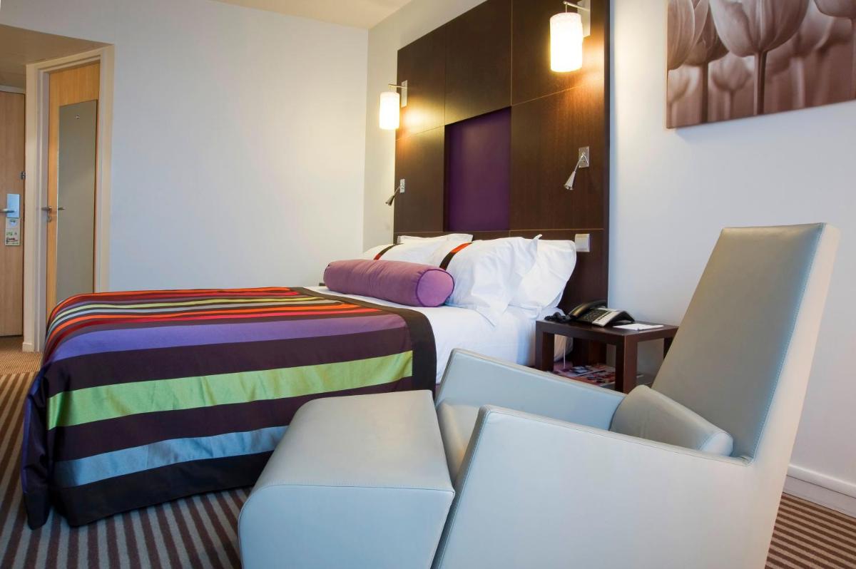 Un ou plusieurs lits dans un hébergement de l'établissement Holiday Inn Dijon Toison D'or by IHG