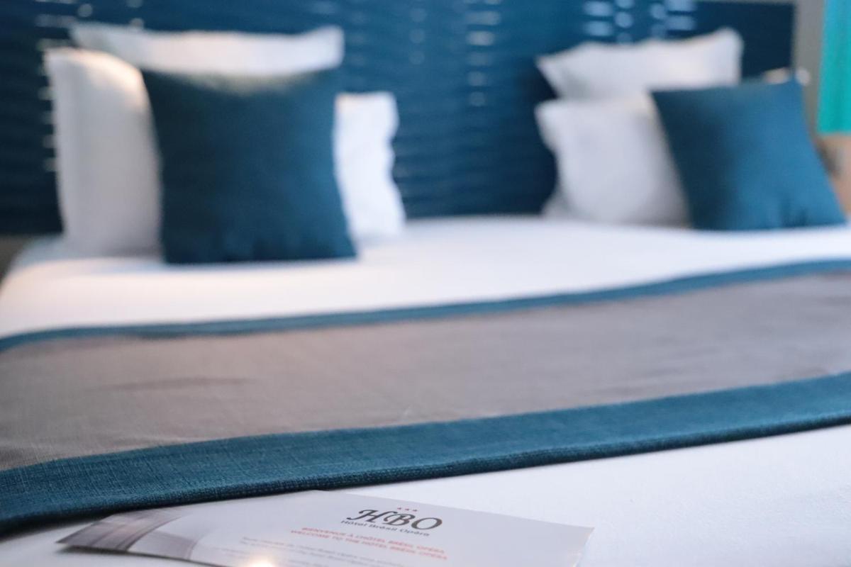 Un ou plusieurs lits dans un hébergement de l'établissement Hôtel Brésil Opéra SPA
