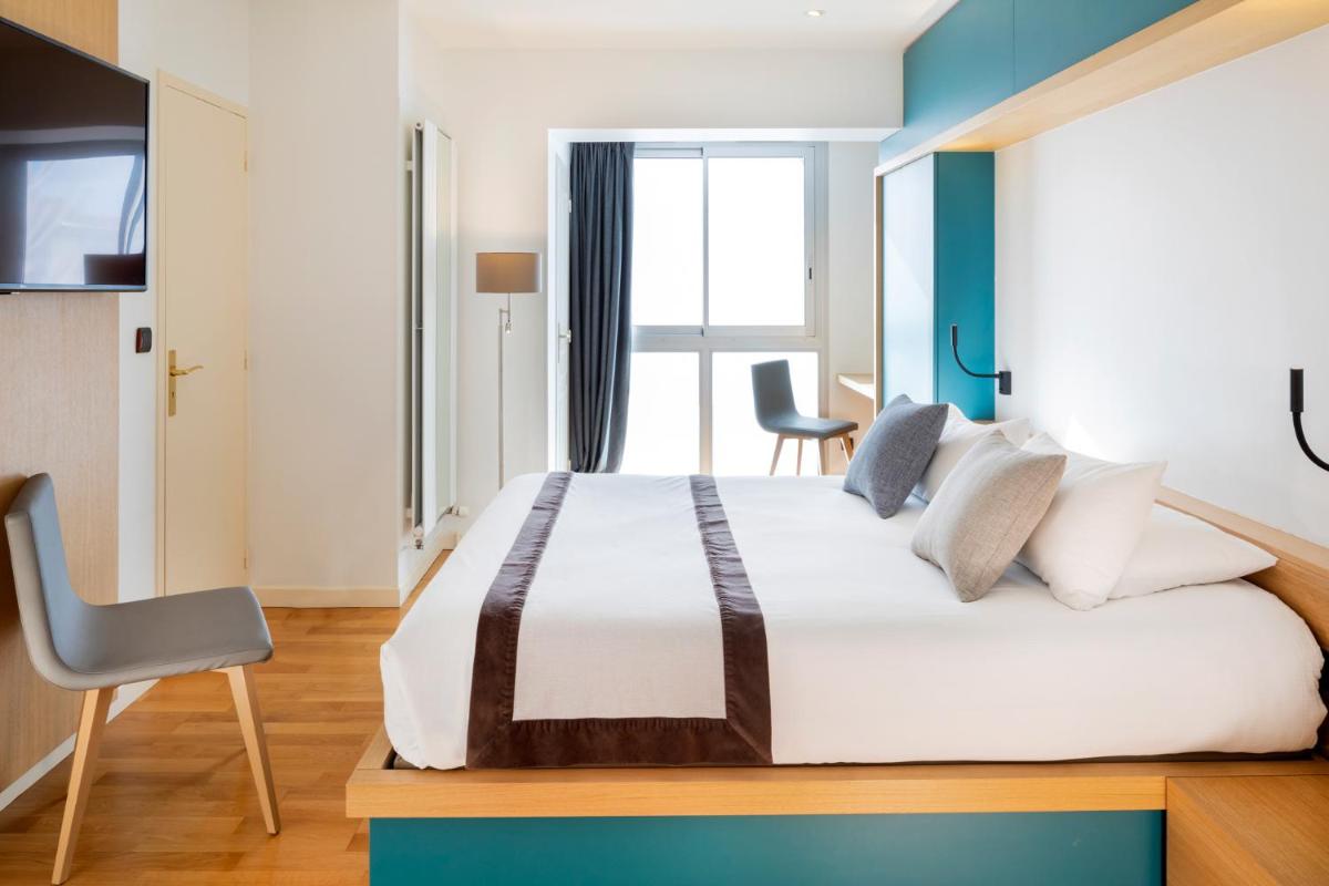 Un ou plusieurs lits dans un hébergement de l'établissement Hotel Du Commerce Spa
