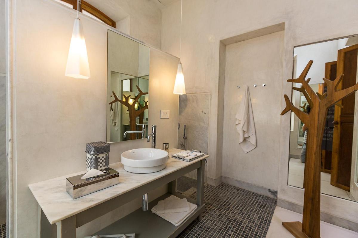 a bathroom with a sink and a mirror at La Villa in Puducherry
