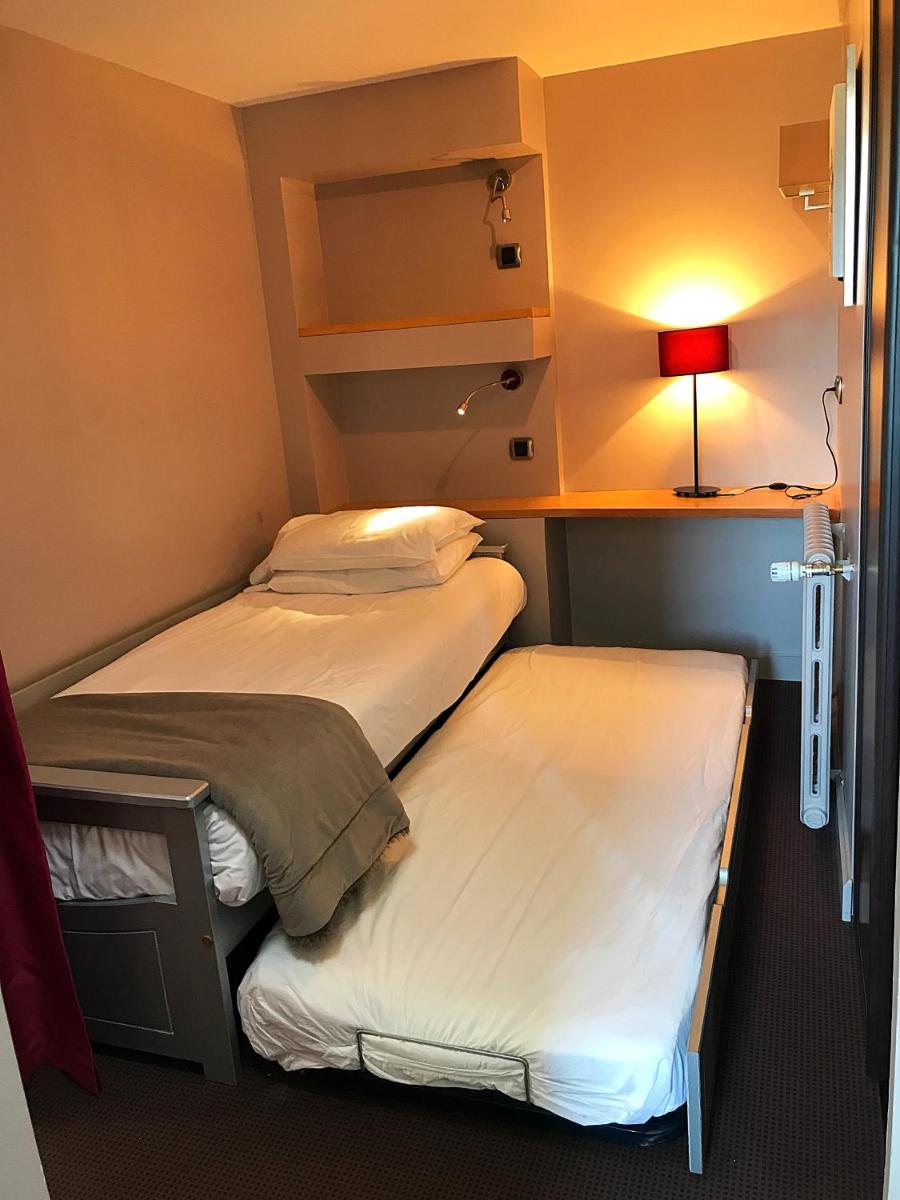 Un ou plusieurs lits dans un hébergement de l'établissement Hotel Corrieu