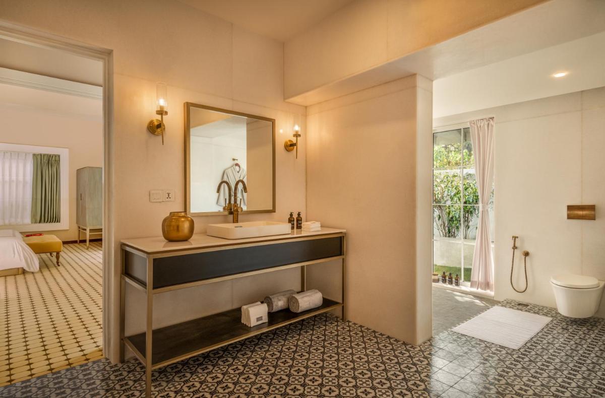 a bathroom with a sink and a mirror at MansionHaus in Anjuna