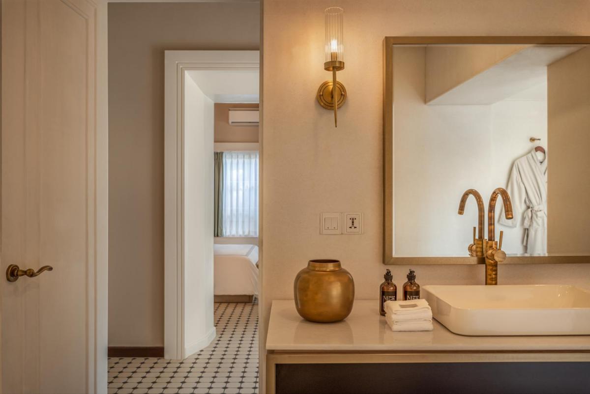 a bathroom with a sink and a mirror at MansionHaus in Anjuna