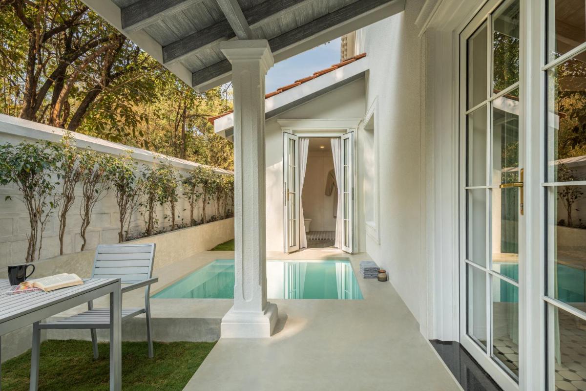 an external view of a house with a pool at MansionHaus in Anjuna