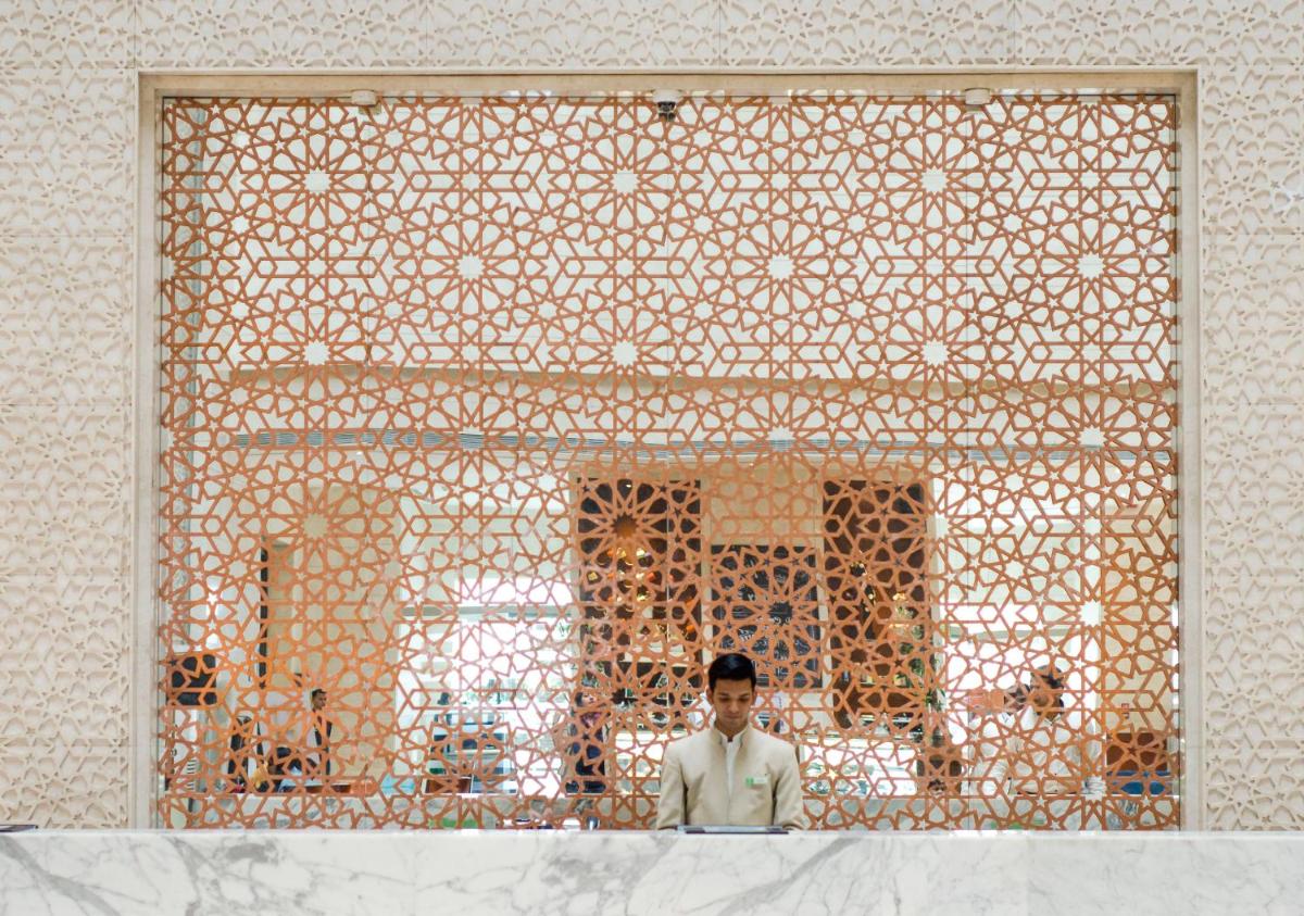 a man is standing in front of a building at Holiday Inn Jaipur City Centre by IHG in Jaipur a man is standing in front of a building at Holiday Inn Jaipur City Centre by IHG in Jaipur