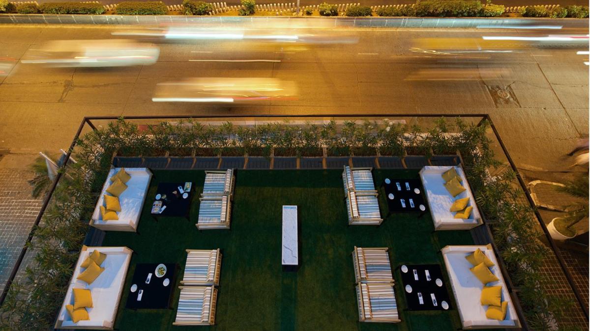an aerial view of a park with chairs and a street at InterContinental Marine Drive Mumbai by IHG in Mumbai