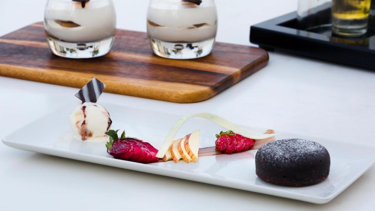 a plate of food with strawberries on a table at InterContinental Marine Drive Mumbai by IHG in Mumbai