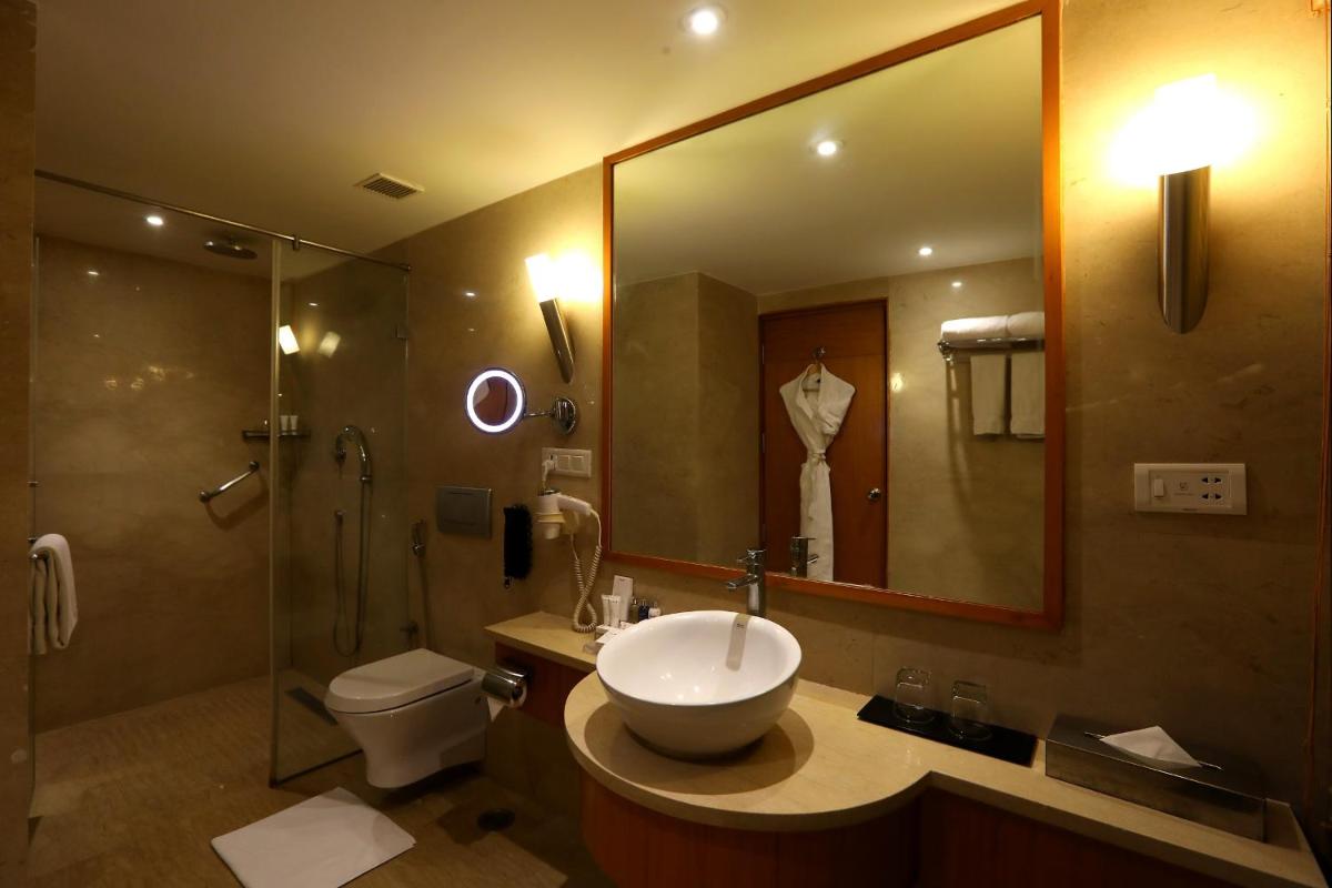 a bathroom with a sink and a toilet and a shower at Radisson Blu Hotel Chennai City Centre in Chennai a bathroom with a sink and a toilet and a shower at Radisson Blu Hotel Chennai City Centre in Chennai