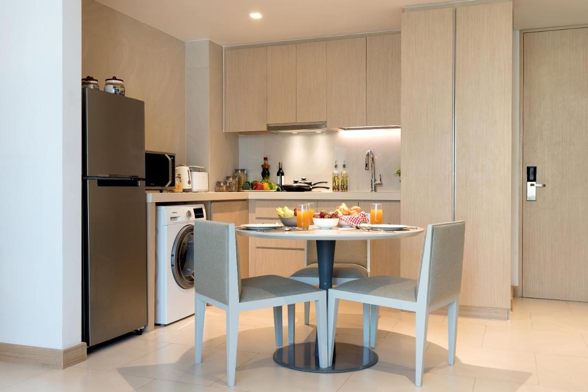 a kitchen with a table and chairs in a kitchen at Citadines OMR Chennai in Chennai a kitchen with a table and chairs in a kitchen at Citadines OMR Chennai in Chennai