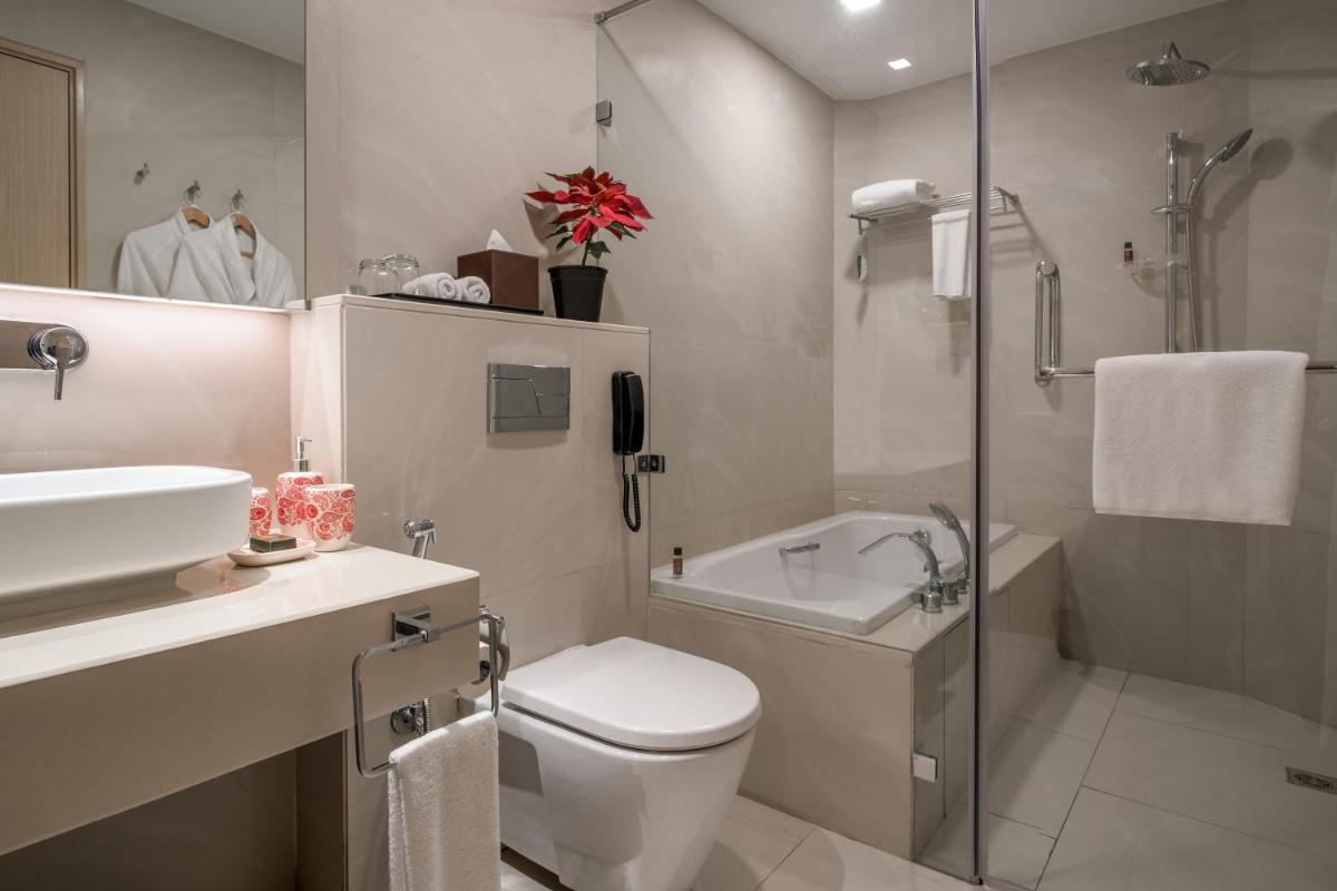 a bathroom with a toilet and a sink and a shower at Citadines OMR Chennai in Chennai a bathroom with a toilet and a sink and a shower at Citadines OMR Chennai in Chennai