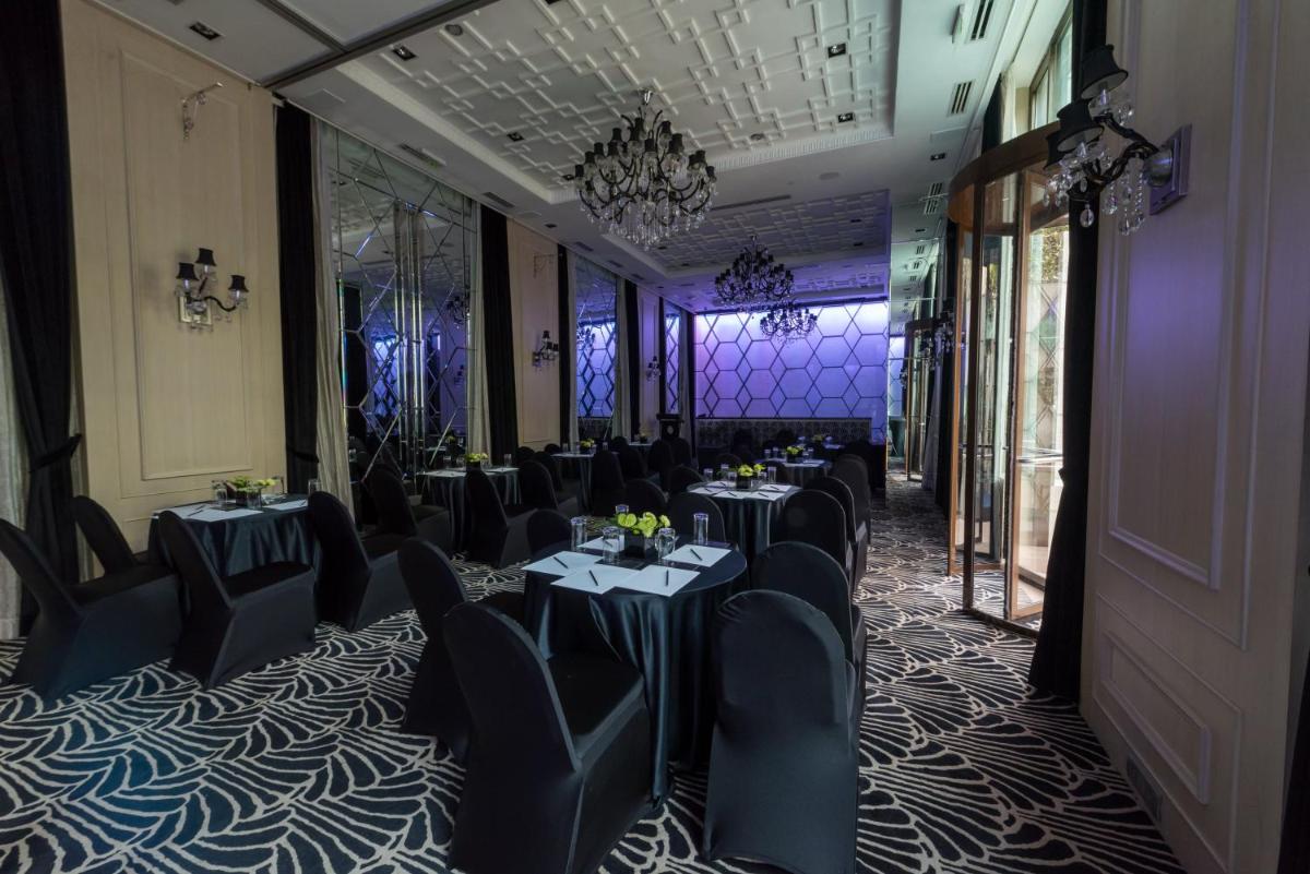 a banquet room with tables and chairs and a chandelier at InterContinental Marine Drive Mumbai by IHG in Mumbai