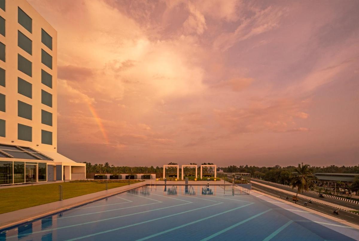 a pool on the roof of a building at O by Tamara, Trivandrum in Trivandrum