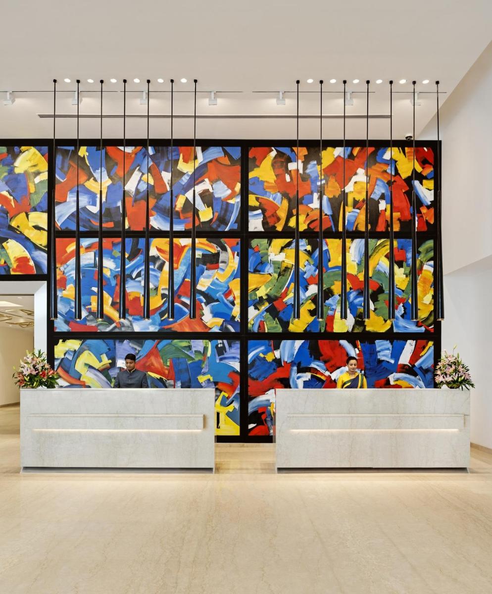 a large colorful painting on the wall of a building at O by Tamara, Trivandrum in Trivandrum