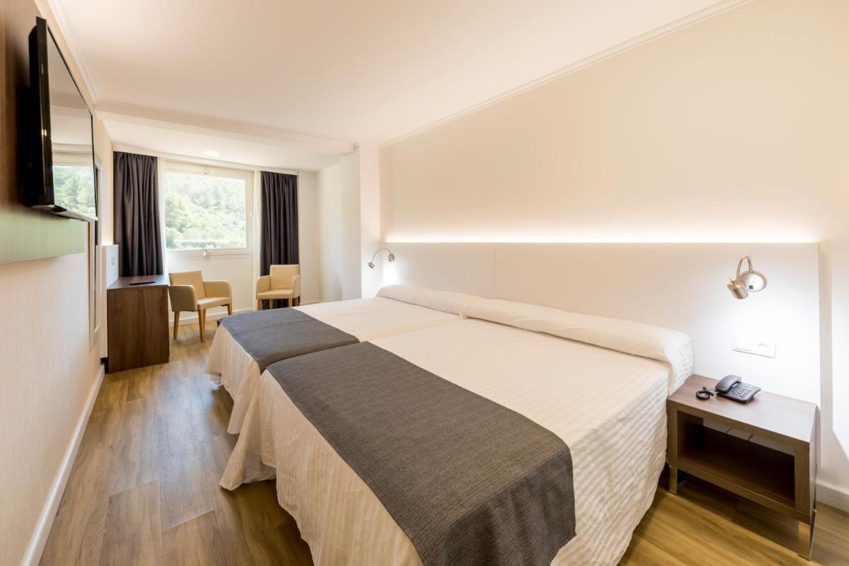 Cama o camas de una habitación en Hotel Rosaleda del Mijares