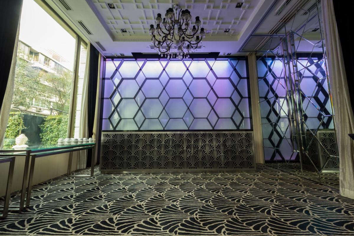a room with a glass wall and a chandelier at InterContinental Marine Drive Mumbai by IHG in Mumbai