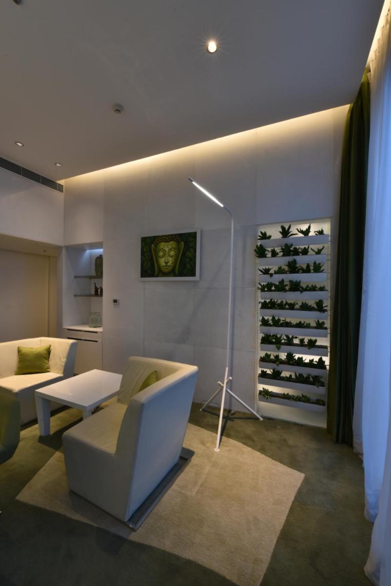 a living room with a couch and a wine cellar at Vivanta New Delhi, Dwarka in New Delhi a living room with a couch and a wine cellar at Vivanta New Delhi, Dwarka in New Delhi