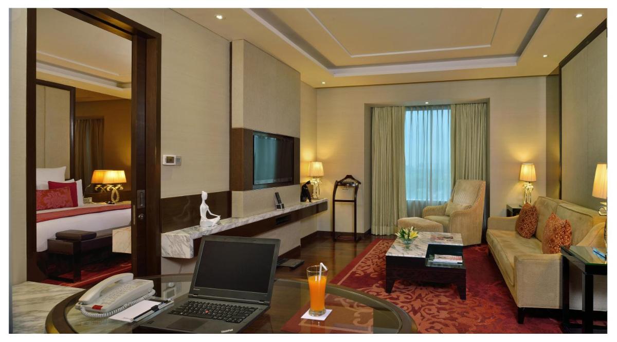 a hotel room with a laptop computer on a desk at Radisson Blu Jaipur in Jaipur