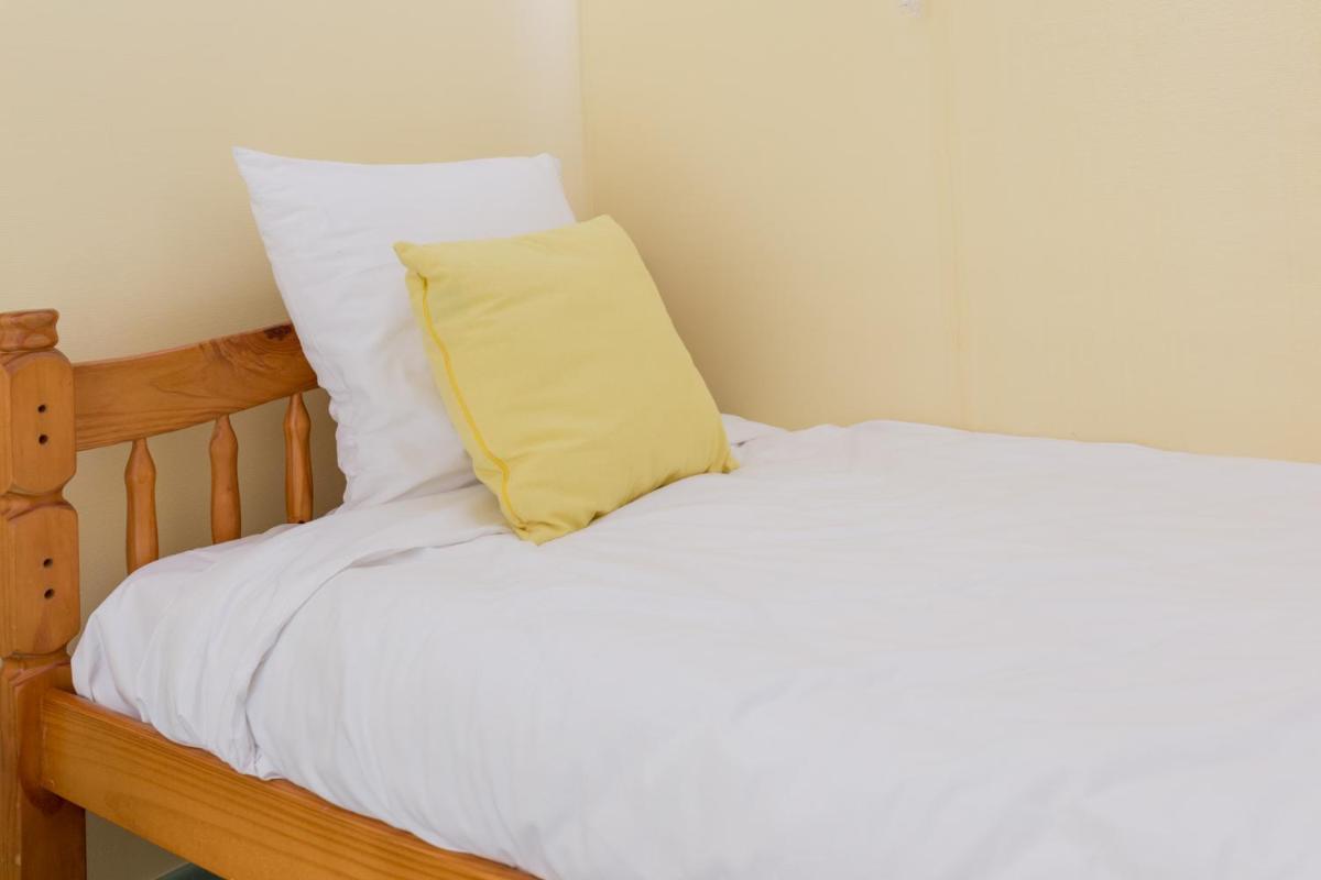 Un ou plusieurs lits dans un hébergement de l'établissement Logis Hotel Le Nuage