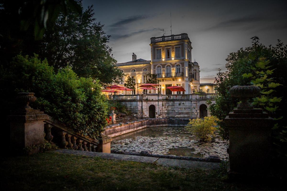 un grand bâtiment avec un étang en face dans l'établissement Chateau du Clos de la Ribaudiere - Teritoria, à Chasseneuil-du-Poitou