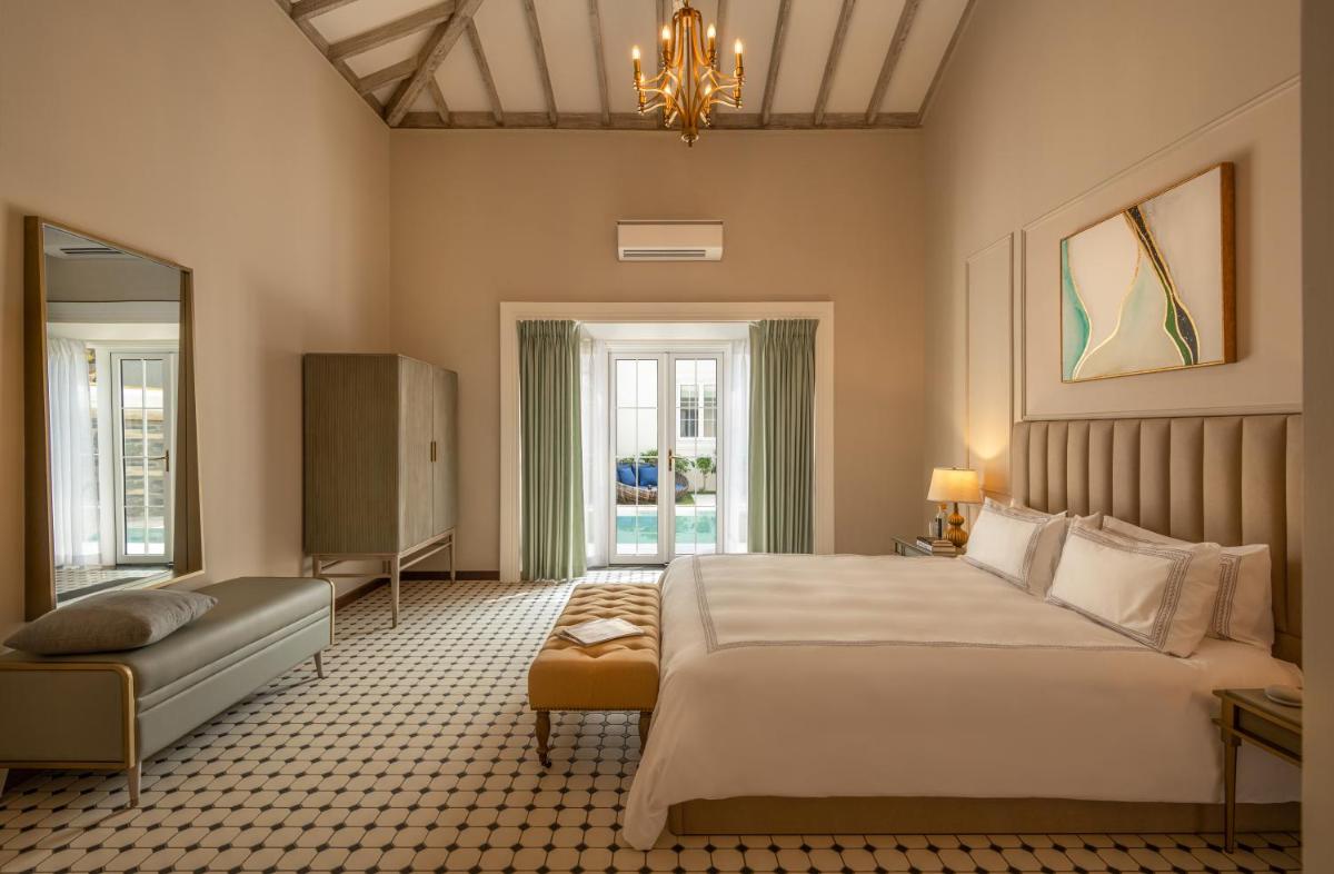 a bedroom with a large bed and a couch at MansionHaus in Anjuna +26 photos