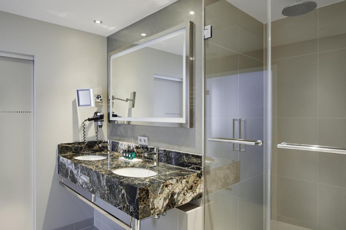 ein Badezimmer mit zwei Waschbecken und einer Dusche in der Unterkunft Hotel Maximilian’s in Augsburg ein Badezimmer mit zwei Waschbecken und einer Dusche in der Unterkunft Hotel Maximilian’s in Augsburg