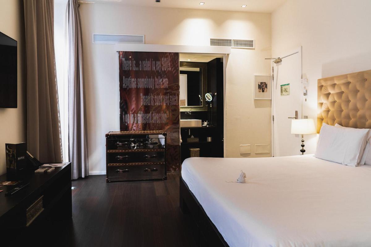 Cama o camas de una habitación en Puro Hotel Oasis Urbano