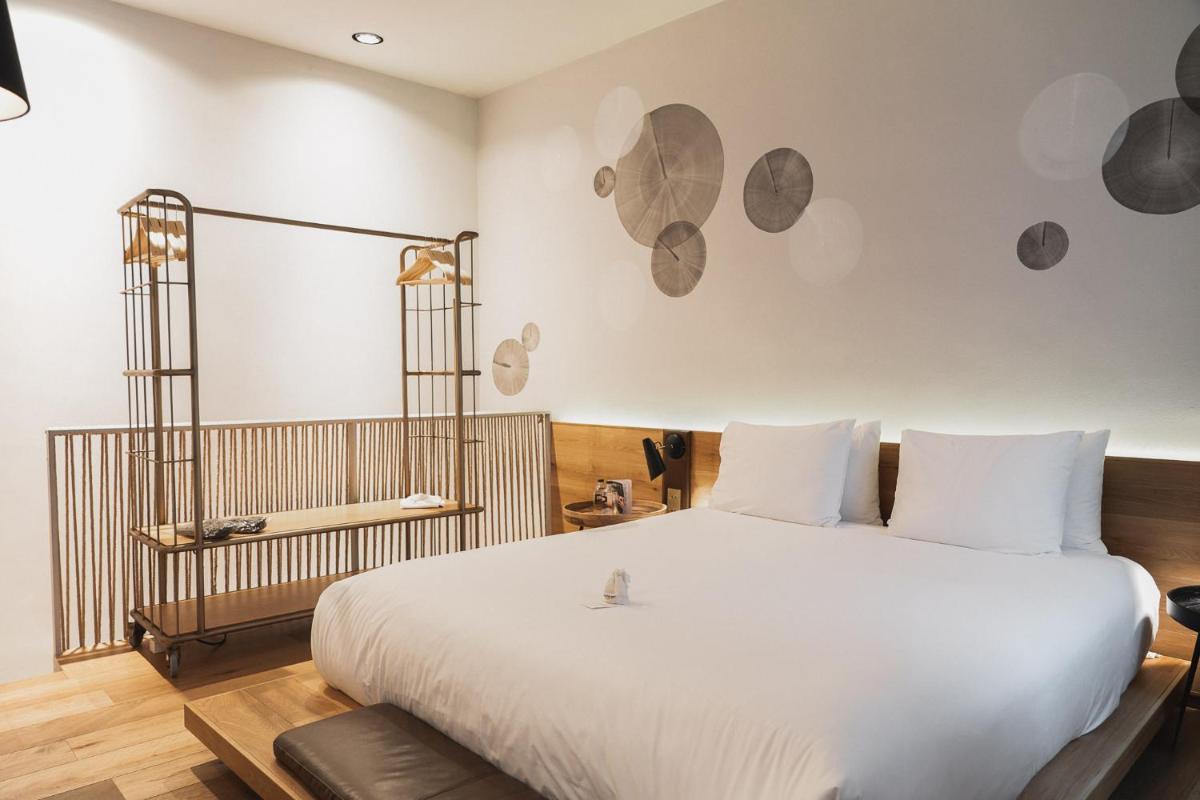 Cama o camas de una habitación en Puro Hotel Oasis Urbano