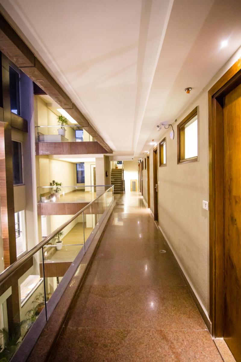 an empty hallway of a building with a glass walkway at Antalya By Divine Ganga Cottage in Rishīkesh