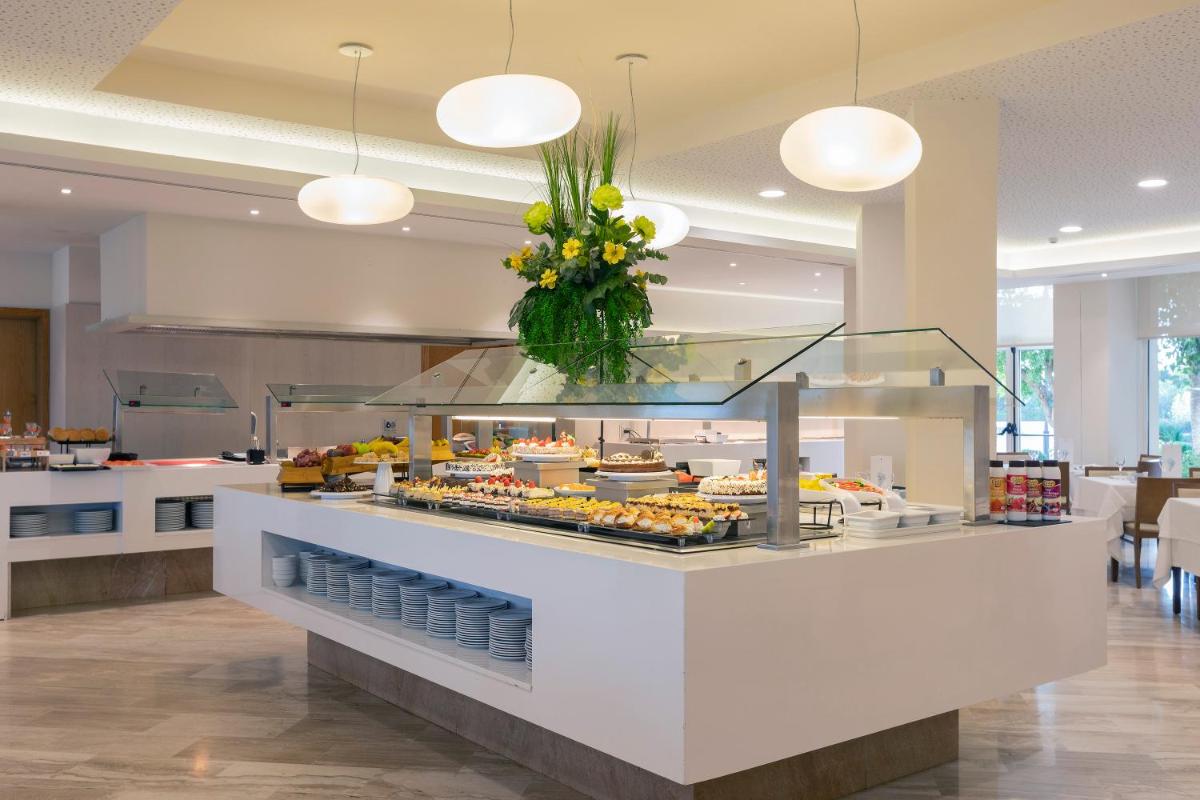 un mostrador de comida con un montón de comida. en Hipotels Dunas Aparthotel, en Cala Millor