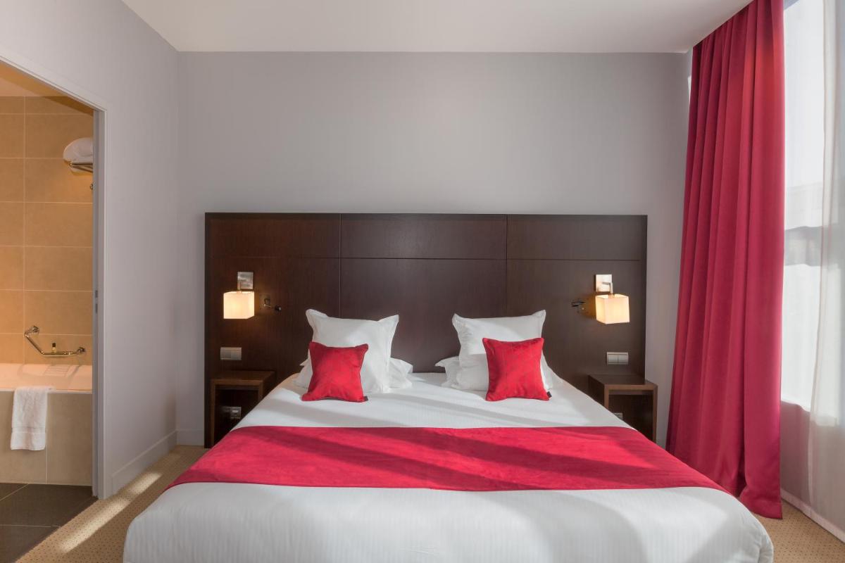 Un ou plusieurs lits dans un hébergement de l'établissement Abbaye des Capucins Spa & Resort