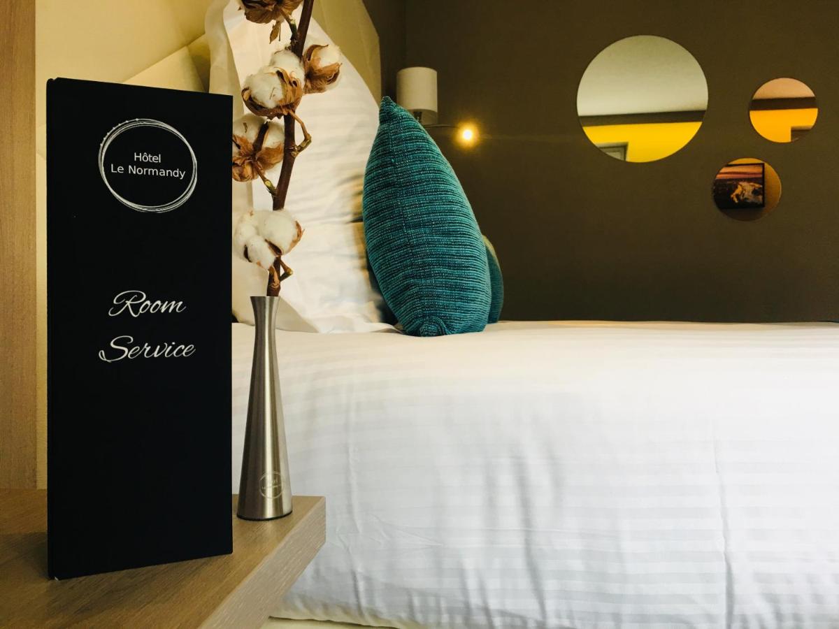 Un ou plusieurs lits dans un hébergement de l'établissement Hotel Normandy