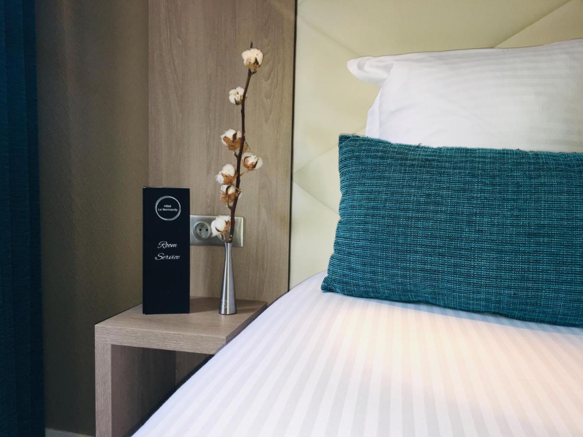 Un ou plusieurs lits dans un hébergement de l'établissement Hotel Normandy