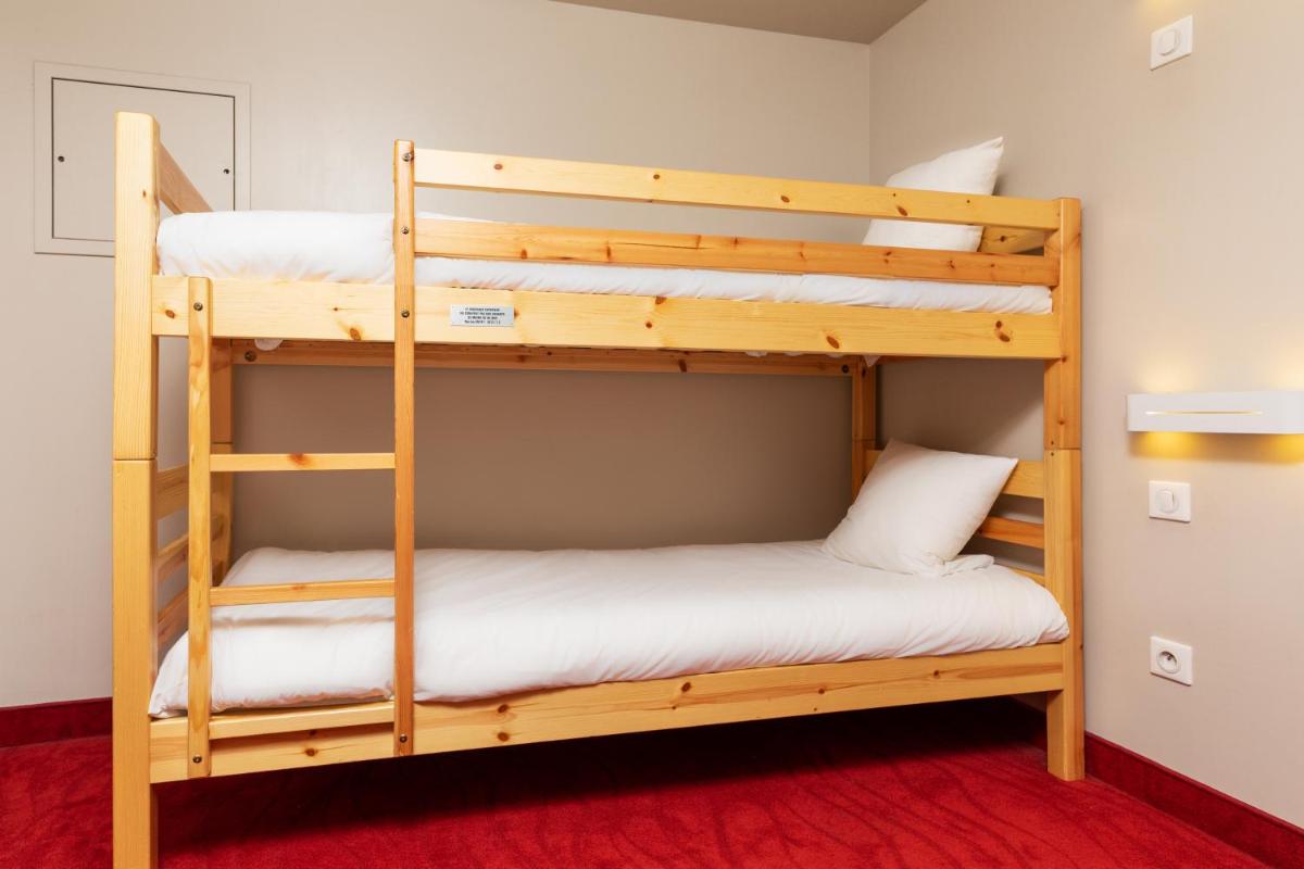 Un ou plusieurs lits dans un hébergement de l'établissement SOWELL HOTELS Le Parc & Spa
