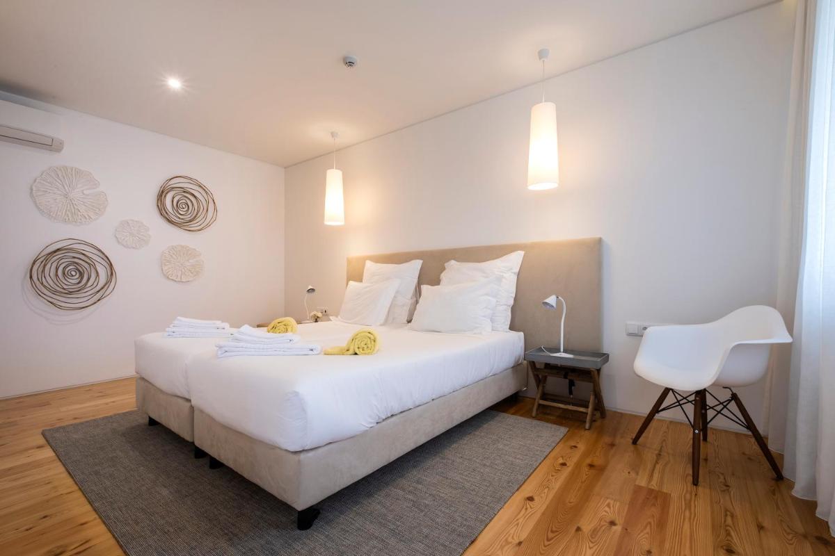 Uma cama ou camas num quarto em Aqua - Pópulo Eco Village